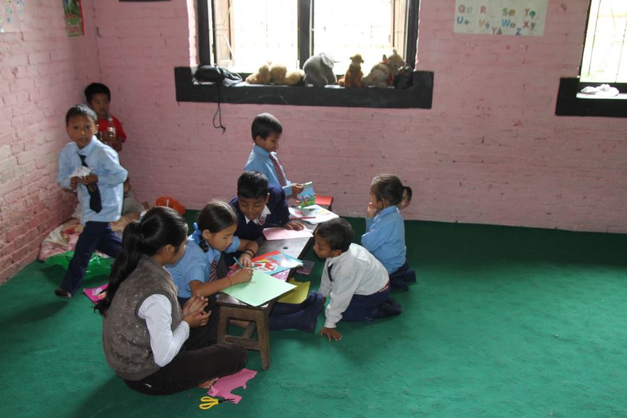 Children reading and working in groups in class
